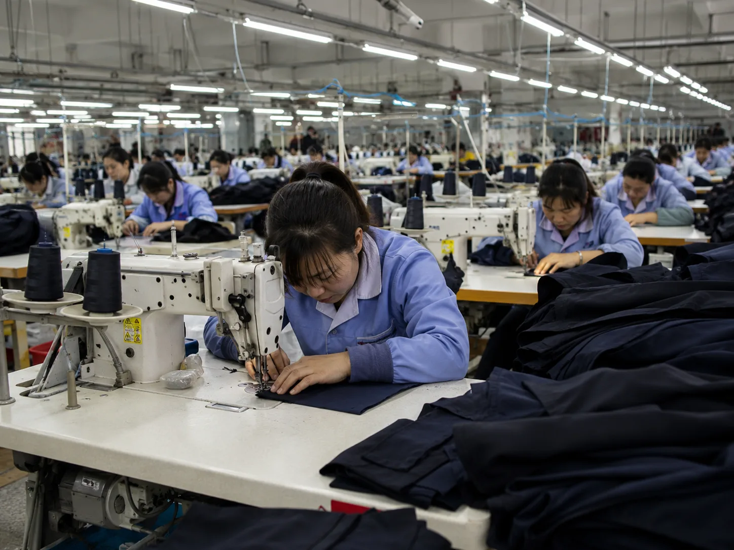 Illustrative Chinese garment sewing workshop and production coordination scene